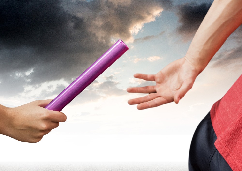Digital composition of hands passing the baton during the race